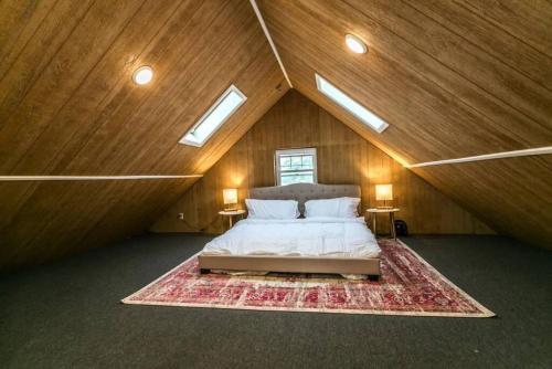 a large bedroom with a bed in a attic at Luxurious 5 BR Home in the Heart of Sylvan Beach in Blossvale
