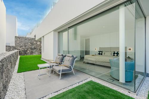 a living room with a bed and a table and chairs at Villa Estándar 5 - Casangular by Upper in Adeje