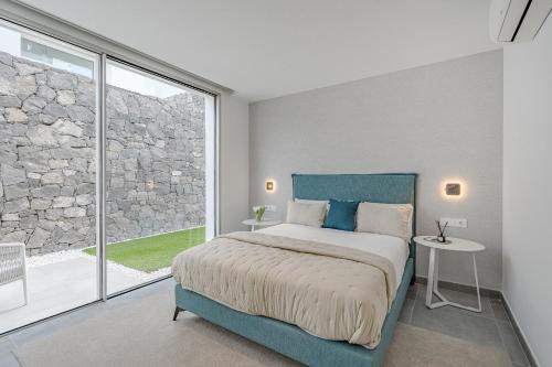 a bedroom with a large bed and a large window at Villa Estándar 5 - Casangular by Upper in Adeje