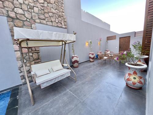 a room with a bed and a table and chairs at Luxury Villa Bali Al Gouna Hurgh in Hurghada