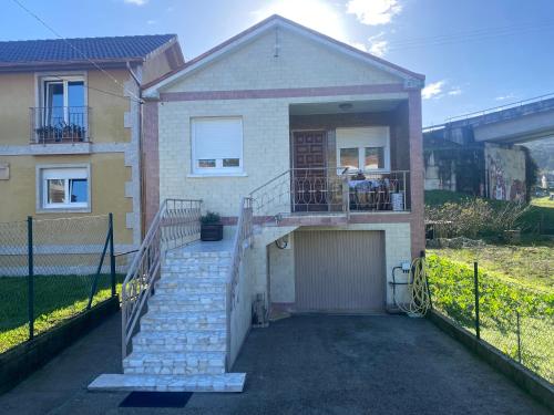 a house with a gate and a garage at BAHIÑA MAR in Baiona