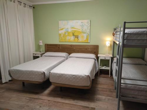 a bedroom with two beds and a bunk bed at Beach and Surf in Peniche