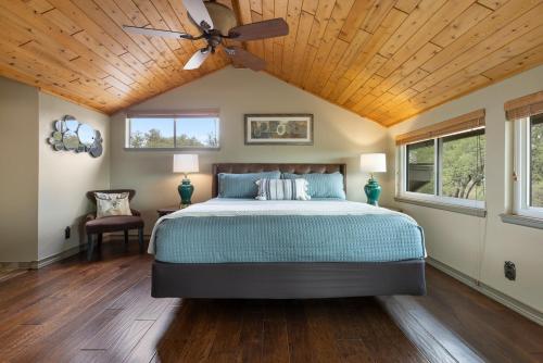 a bedroom with a bed with a wooden ceiling at Wine Country Retreat – with a lake view! in Spicewood
