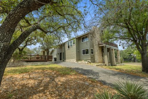 an exterior view of a house with a tree at Wine Country Retreat – with a lake view! in Spicewood