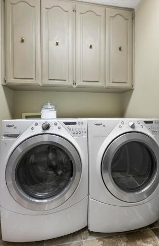 a white washer and dryer in a kitchen at Wine Country Retreat – with a lake view! in Spicewood
