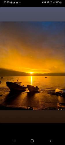 dois barcos sentados na praia ao pôr do sol em Hospedaje Donde Grillo em Puerto Cisnes
