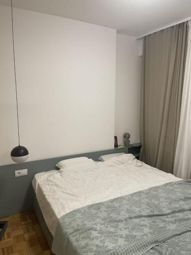 a bedroom with a white bed and a window at Green Place in Vračar (historical)