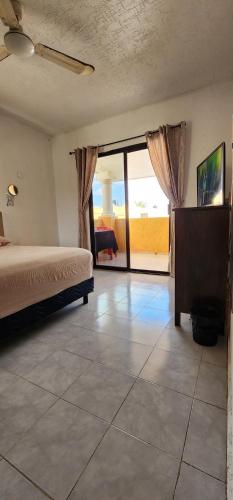 a bedroom with a bed and a view of a patio at Piso completo. Hasta 9 personas. Norte MID in Mérida