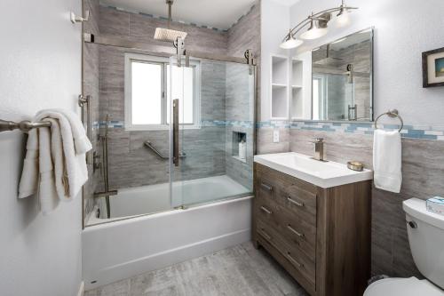 a bathroom with a tub and a sink and a shower at Seaspray Condos 206B in Fort Walton Beach