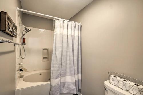 a bathroom with a shower curtain and a toilet at Anglers Pointe in Branson