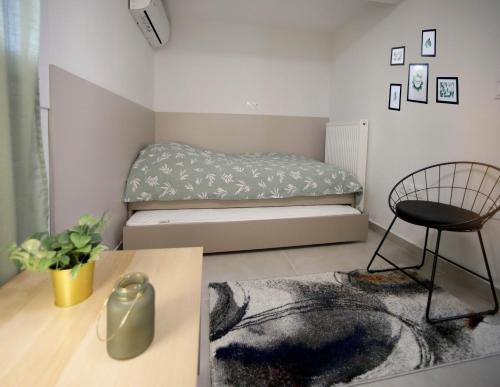a small bedroom with a bed and a chair at Cozy Like Home in Maniákoi