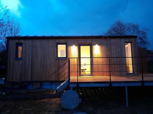 a small house with lights on the front of it at Au p'tit pré des salers in Hamois