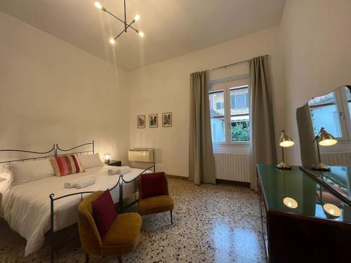 a bedroom with a bed and two chairs and a television at La Villetta dell'Orto in Florence