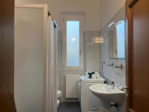 a white bathroom with a sink and a toilet at La Villetta dell'Orto in Florence