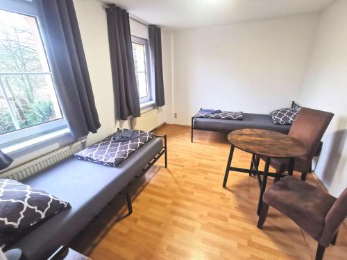 a living room with a couch and a table at Monteurzimmer am Bahnhof Biesenthal - 3 große Apartments in Biesenthal
