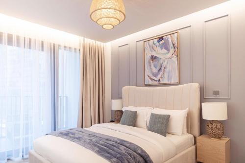 a bedroom with a bed and a large window at Trophy - Ahad Residence Business Bay Suite in Dubai