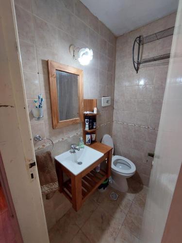 a bathroom with a sink and a toilet at Sol y Luna Hospedajes in San Bernardo