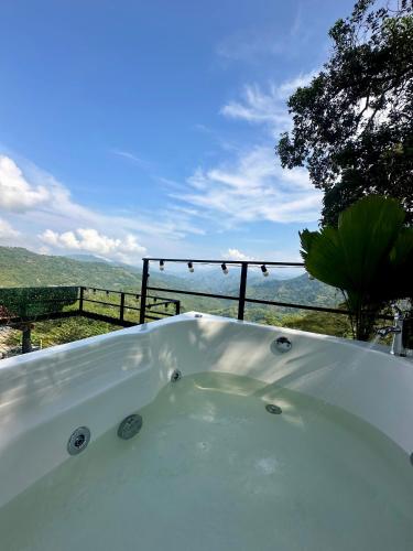 a bath tub with a view of the mountains at Cabañas Bellavista La Vega in La Vega