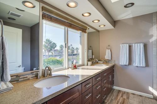 a bathroom with two sinks and a large window at Huntington Beach Condo - Walk to the Ocean! in Huntington Beach