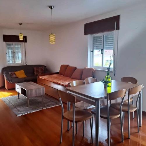 a living room with a table and a couch at Casa das Borboletas in Évora