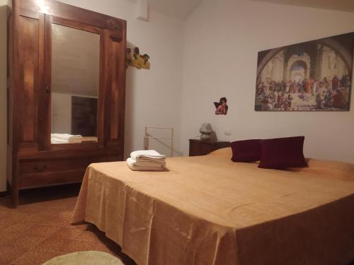 a bedroom with a bed with a dresser and a mirror at Il Giramondo in Montelabbate