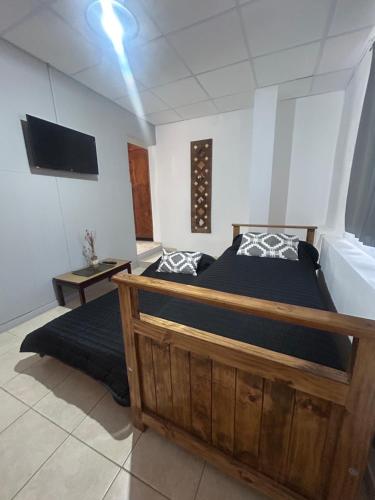 a bedroom with two beds and a flat screen tv at Departamento del Centro in Chilecito