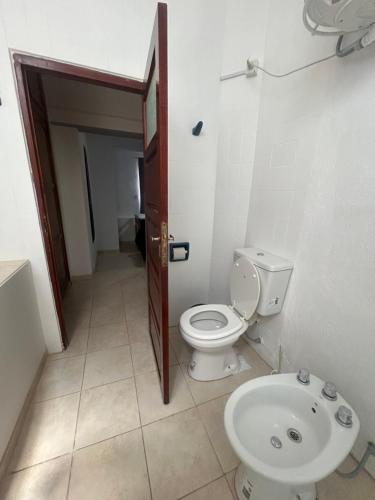 a bathroom with a toilet and a sink at Departamento del Centro in Chilecito
