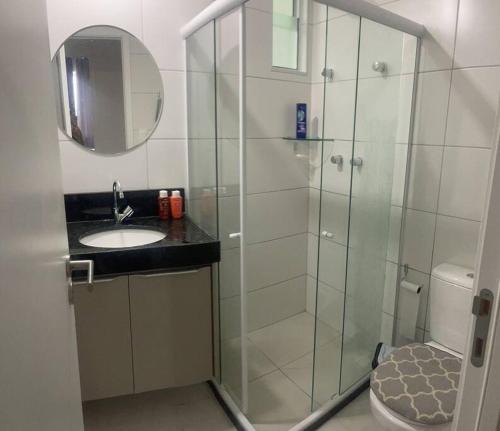 a bathroom with a shower with a sink and a toilet at Apartamento Ponta Verde. Edf. Promenade II in Maceió