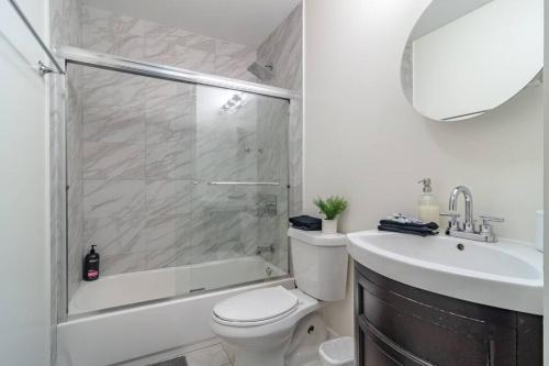 a bathroom with a shower and a toilet and a sink at McCormick Place 420 friendly 2br/2ba with optional parking for up to 6 guests in Chicago