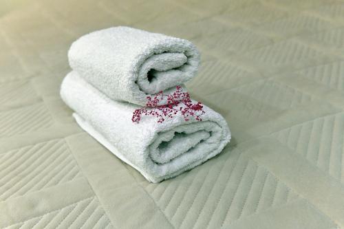 stos ręczników siedzących na łóżku w obiekcie woolway studios w mieście Argavand