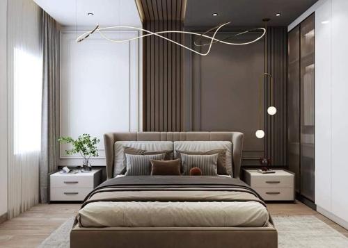 una camera da letto con un grande letto con due comodini di بورتو السخنه ترحب بكم - Aprag Porto Alsokhna a Suez