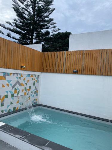 a fountain in a swimming pool with a fence at Casa de Santa Catarina - Ponta Delgada in Ponta Delgada
