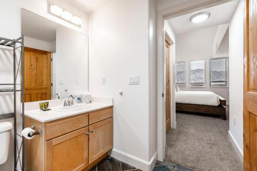 a bathroom with a sink and a bed in a room at Crestview Condominiums in Park City