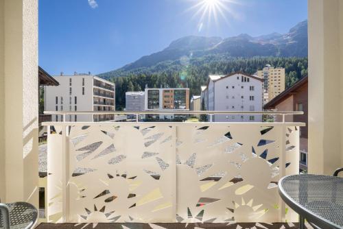 a balcony with a view of a city at Hotel Sonne St. Moritz 3* Superior in St. Moritz