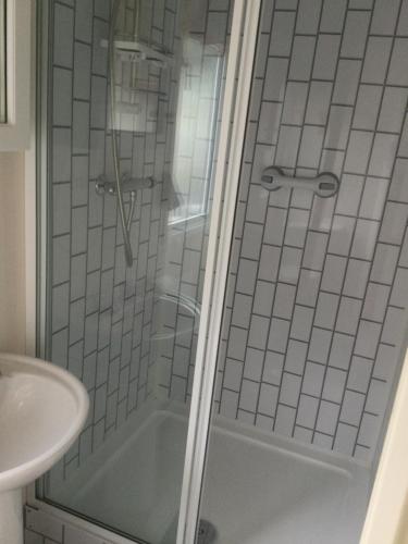 a bathroom with a shower and a sink at H2 in Aberystwyth