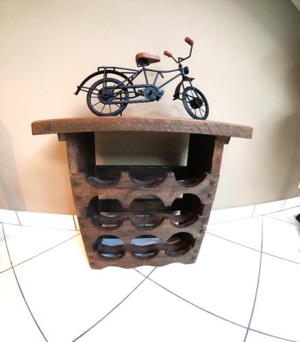 a bike is sitting on a shelf with wine bottles at Skyview Suite in Oostduinkerke
