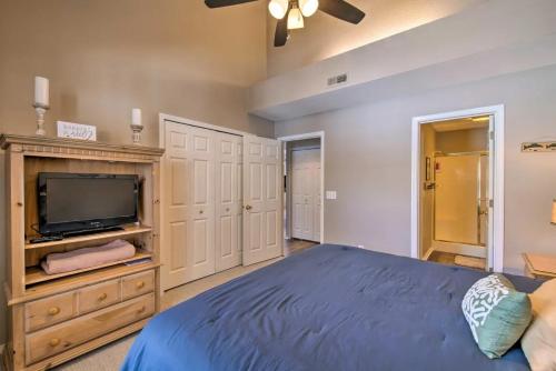 a bedroom with a bed and a flat screen tv at Anglers Pointe in Branson
