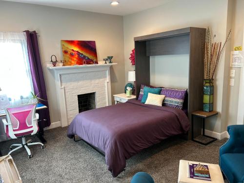 a bedroom with a bed and a fireplace at VIP Suites for Business Women, Nurses, College Moms Traveling to Indianapolis in Indianapolis