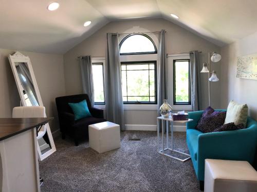a living room with a blue couch and a window at VIP Suites for Business Women, Nurses, College Moms Traveling to Indianapolis in Indianapolis