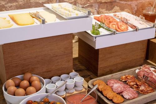 a buffet with eggs eggs meats and other foods at Palau Sa Font in Palma de Mallorca
