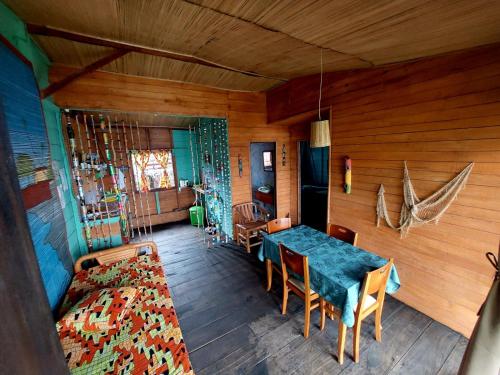 a dining room with a blue table and chairs at GENTE D'AQUI Ngê D'ai êê in São Tomé