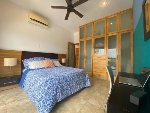 1 dormitorio con 1 cama y escritorio con ordenador portátil en Oceanview Condo - Club Cerralvo, en El Sargento