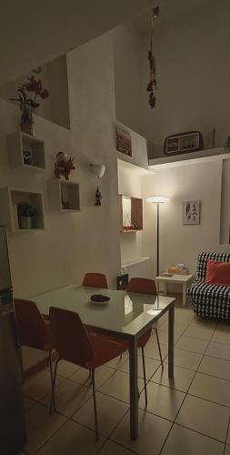 a living room with a table and chairs and a couch at Gemme Fiorentine Apartments in front of the train station 5 minutes from the centre Free parking in Florence