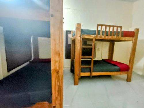 a bunk bed and a chair in a room at The Last Try - Secret Ashram Coorg in Siddapur