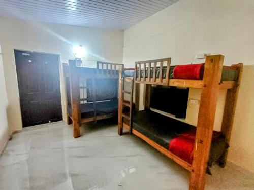 a room with two bunk beds in a room at The Last Try - Secret Ashram Coorg in Siddapur