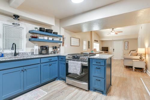 a kitchen with blue cabinets and a living room at about 3 Mi to Lake Texoma Kingston Family Retreat in Kingston