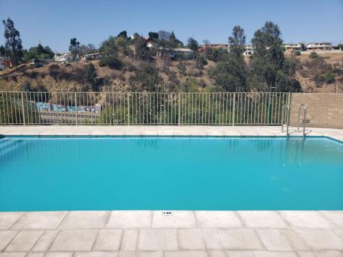una piscina con recinzione e acqua blu di Hermoso y cómodo departamento en Viña del Mar a Viña del Mar