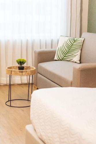 a living room with a couch and a table at Grand Sirenis San Andres in San Andrés