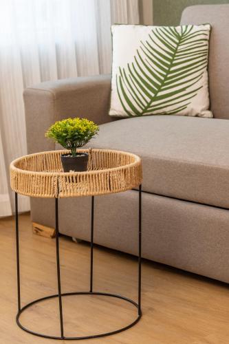 a rattan coffee table in front of a couch at Grand Sirenis San Andres in San Andrés