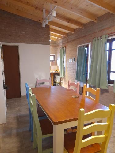 a dining room with a wooden table and chairs at Rawson casa a minutos del centro y de Playa Unión in Rawson